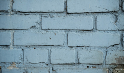Texture of an old paint covered brick wall. Background image of an abandoned brick wall with painted over paint