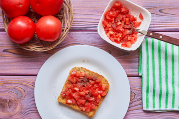 Toasted tomato toast. Vegetarian bruschetta with fresh tomatoes and pepper on white bread.