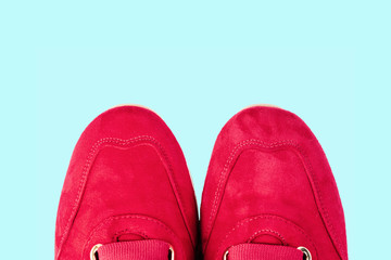modern red and white woman's shoes isolated on blue background