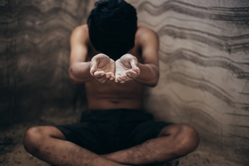 hands poor child or beggar begging you for help sitting at dirty slum. concept for poverty or...