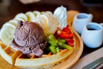 dessert made of brownie and green tea ice cream together with whipped cream on the white plate
