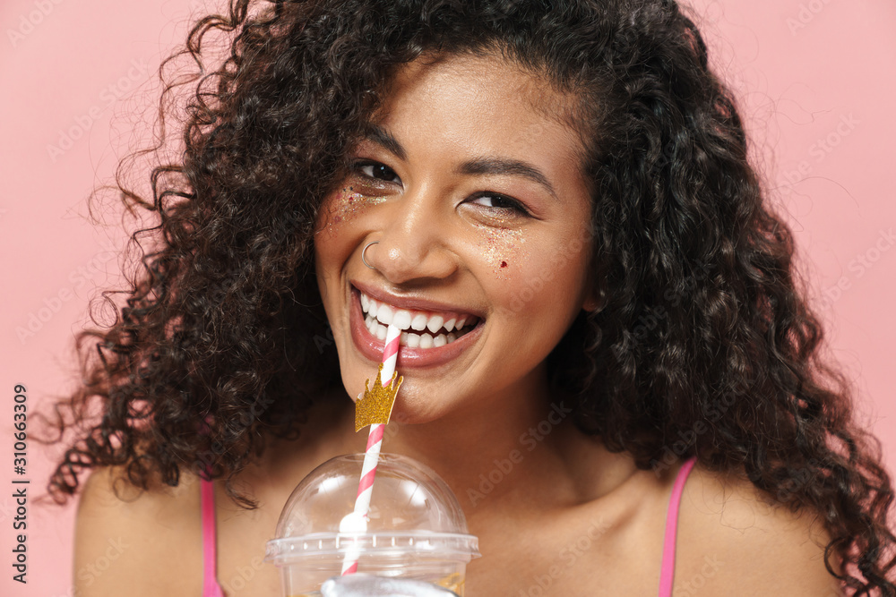Wall mural Image of happy african american woman smiling and drinking soda - Wall murals