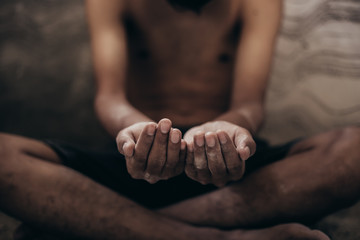 hands poor child or beggar begging you for help sitting at dirty slum. concept for poverty or...