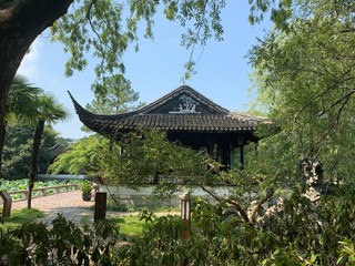 Pagoda partially obscured by greenery in a park