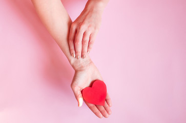 hands holding red heart on blue background, health care, hope, love, organ donation, wellbeing,...