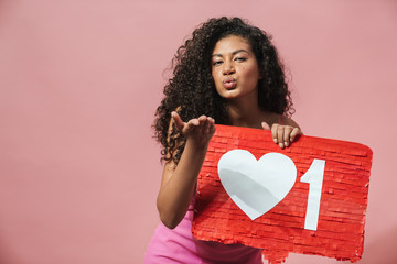 Image of nice african american woman holding placard and sending air kiss