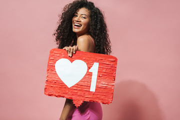 Image of funny african american woman holding placard and laughing