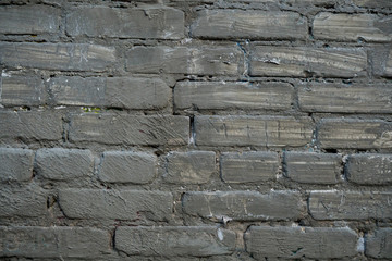 Texture of an old paint covered brick wall. Background image of an abandoned brick wall with painted over paint