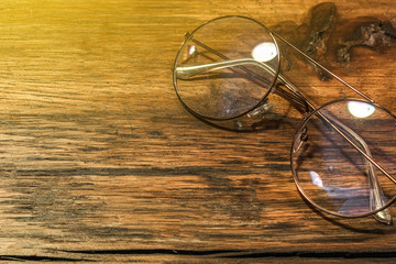Single simple Eye glasses on the wooden table with copy space