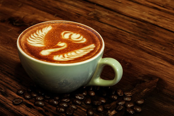 cup of the latte art coffee with warm light