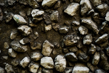 Texture photo of rough concrete plaster with sprinkled gravel