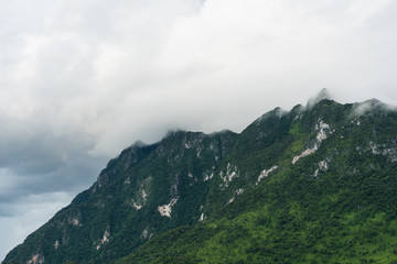 Naklejka premium Mountains, tropical forests and rain clouds in Northern, Thailand.(Chiang Dao Province)