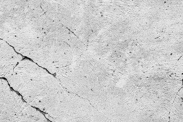 Texture of a concrete wall with cracks and scratches which can be used as a background