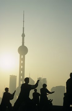 China Shanghai silhouettes of people against city skyline (Oriental Pearl TV Tower)