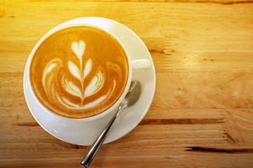 cup of the latte art coffee with warm light