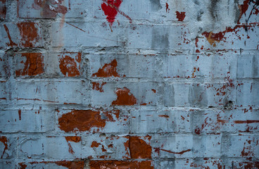Texture of an old paint covered brick wall. Background image of an abandoned brick wall with...