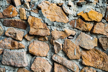 The texture of the old masonry. Background image of a stone-lined wall