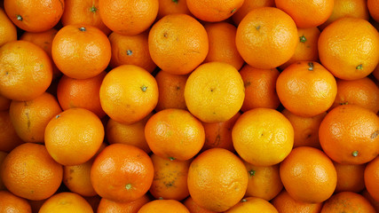 Bunch of fresh mandarin oranges on market, top view