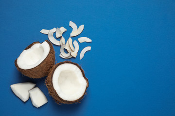 Flat lay composition with tasty coconut chips on blue background. Space for text