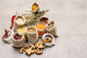 Zero waste food shopping concept. Cereals, pasta, legumes, dried mushrooms, spices. Sustainable lifestyle, old wooden boards background