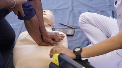 Rescuers teaches how to pump a heart, silicone rubber dummy.                                     