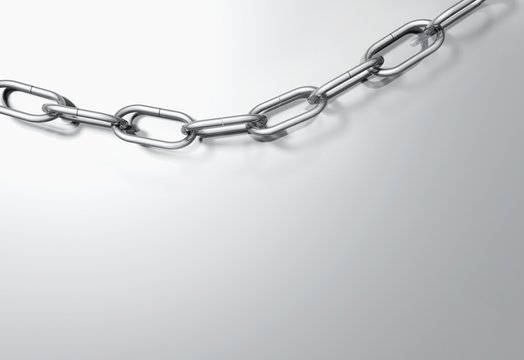 Closeup of metal chain over grey background