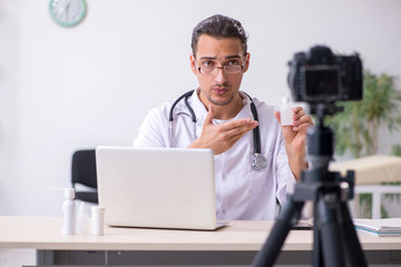 Young male doctor recording video for his blog