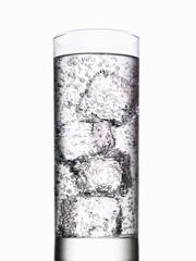 Glass of water with ice cubes on white background