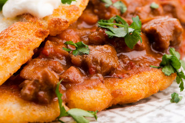 Potato pancakes with meat, vegetable, tomato and parsley