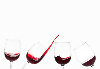Glasses of red wine and splashes on a white background. Free space for text