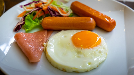 Breakfast needs sausages with fried eggs and ham.