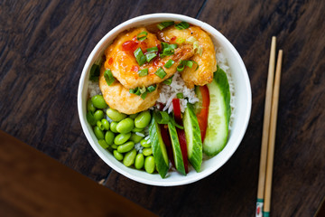 Take Away Healthy Buddha Bowl with Shrimp, Edamame Beans, Cucumber and Basmati Rice / Poke Bowl in Plastic Box Package or Container.