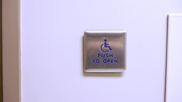 Handicap push to open button on wall in doctors office for easy accessibility