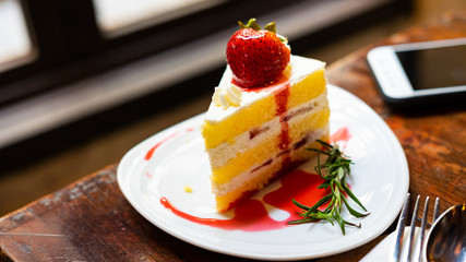 Strawberry cake is topped with stretched caramel.