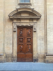Detail of carved door and carved mantle on an old building in Italy