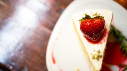 Strawberry cake is topped with stretched caramel.
