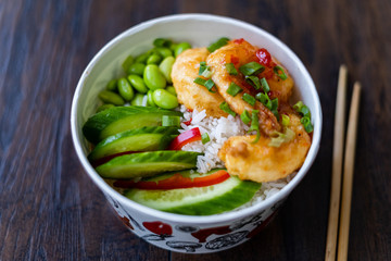 Take Away Healthy Buddha Bowl with Shrimp, Edamame Beans, Cucumber and Basmati Rice / Poke Bowl in Plastic Box Package or Container.