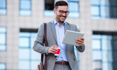 Businessman drinking coffee and checking notes with tablet. Business, lifestyle concept