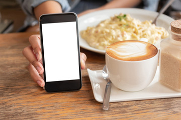 Fototapeta na wymiar Blank screen mobile in restaurant And morning coffee.