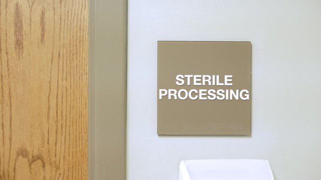 Sterile Processing Sign on wall in medical office hospital. slider movement of establishing shot for room inside doctors office.
