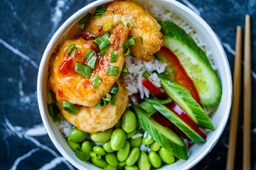 Take Away Healthy Buddha Bowl with Shrimp, Edamame Beans, Cucumber and Basmati Rice / Poke Bowl in Plastic Box Package or Container.