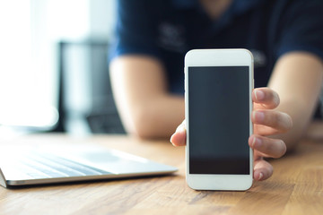 Close up of women's hands holding cell telephone with blank copy space scree for your advertising text message or promotional content