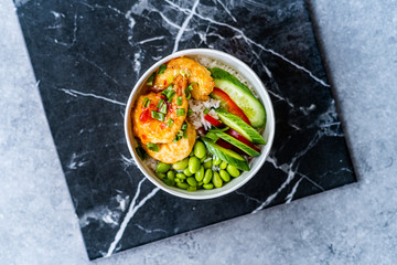 Take Away Healthy Buddha Bowl with Shrimp, Edamame Beans, Cucumber and Basmati Rice / Poke Bowl in Plastic Box Package or Container.