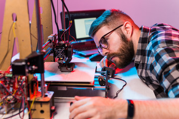 Male architect using 3D printer in office