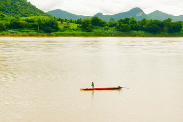 Pictures of small boats and fishermen on the Mekong River and mountains. Kaeng Khu Khu District, Chiang Khan Province, Loei Province