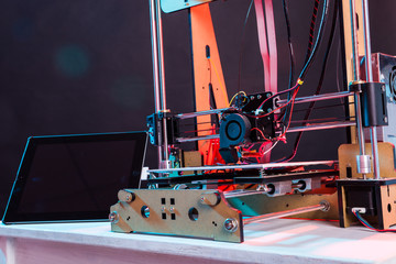 3d printer working and printing plastic prototype