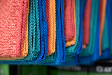Red, orange, blue, green and yellow wiping clothes in a shop