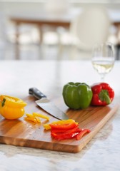Peppers On Chopping Board In Kitchen
