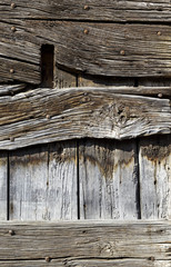 Close up of old weathered wooden planks with hand forged nails