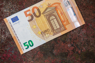 50 Euro bill on a rusty metalic table money grow growing economy economic